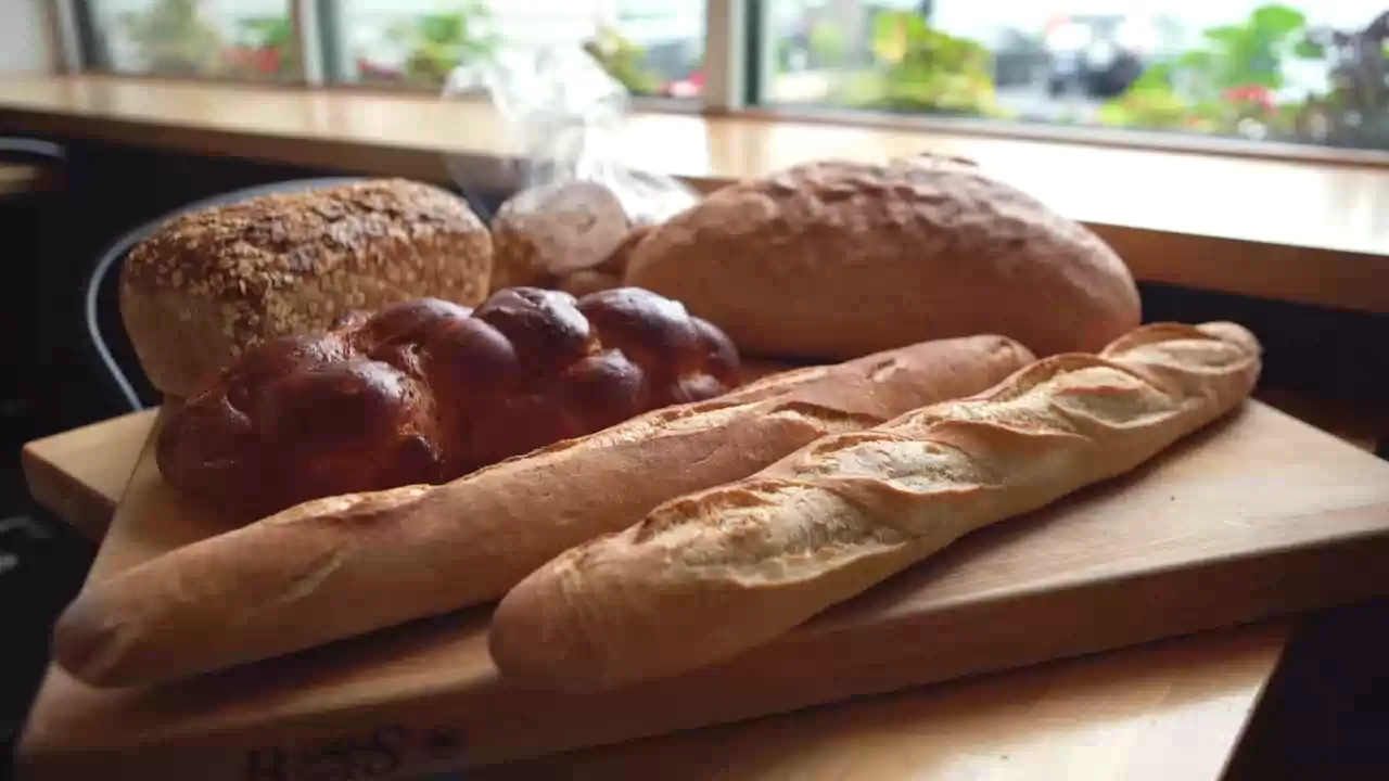 An assortment of bakery loaves beside the window