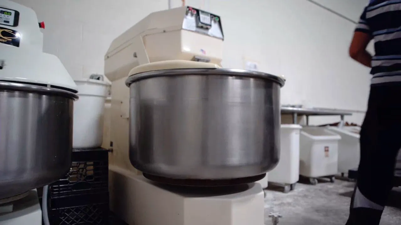 Bakery mixers and dough bins in the Hartford Baking Co production room